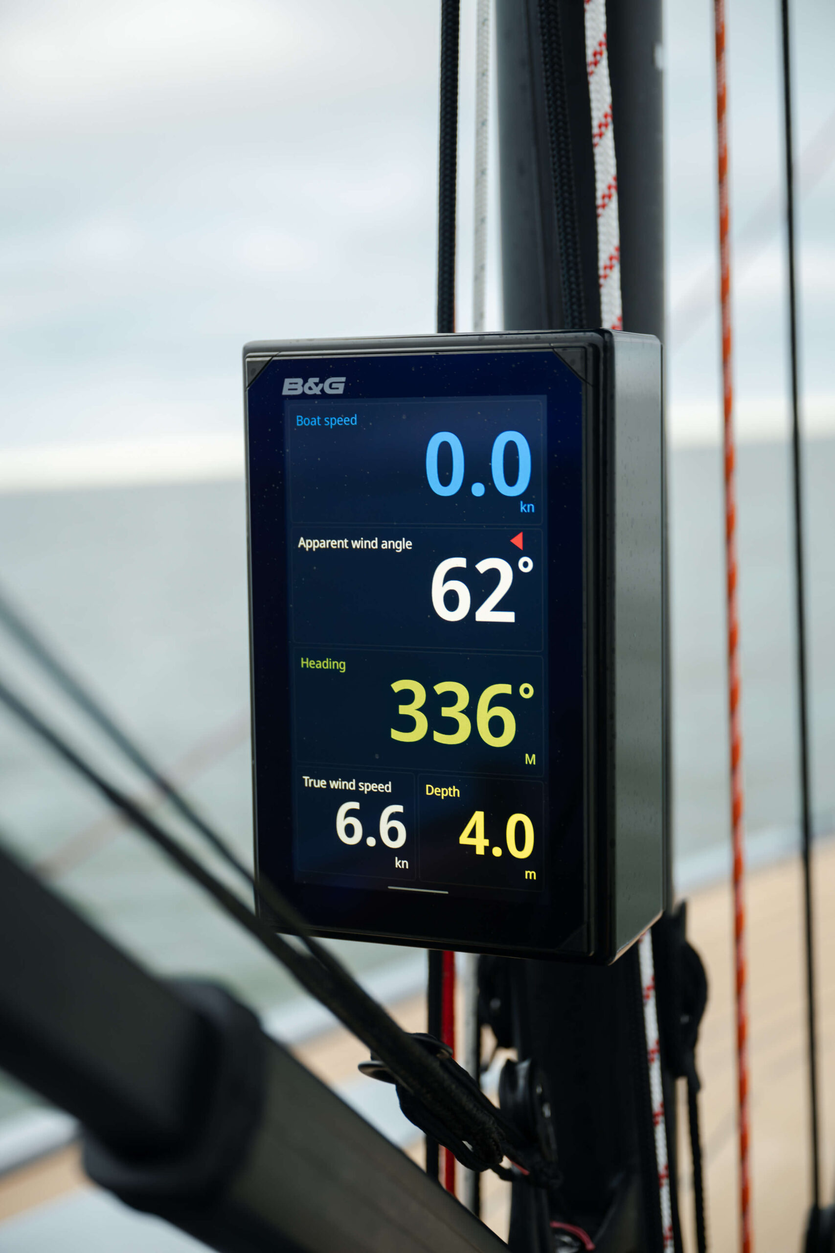 Sailing instrument display showing boat speed 0.0 kn and apparent wind 62&deg;, heading 336&deg; on a boat dashboard.
