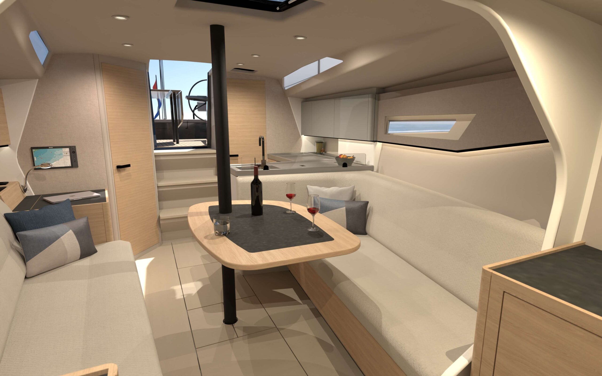 Modern yacht cabin with U-shaped seating around a wood dining table, wine bottle and glasses, galley visible in the background.